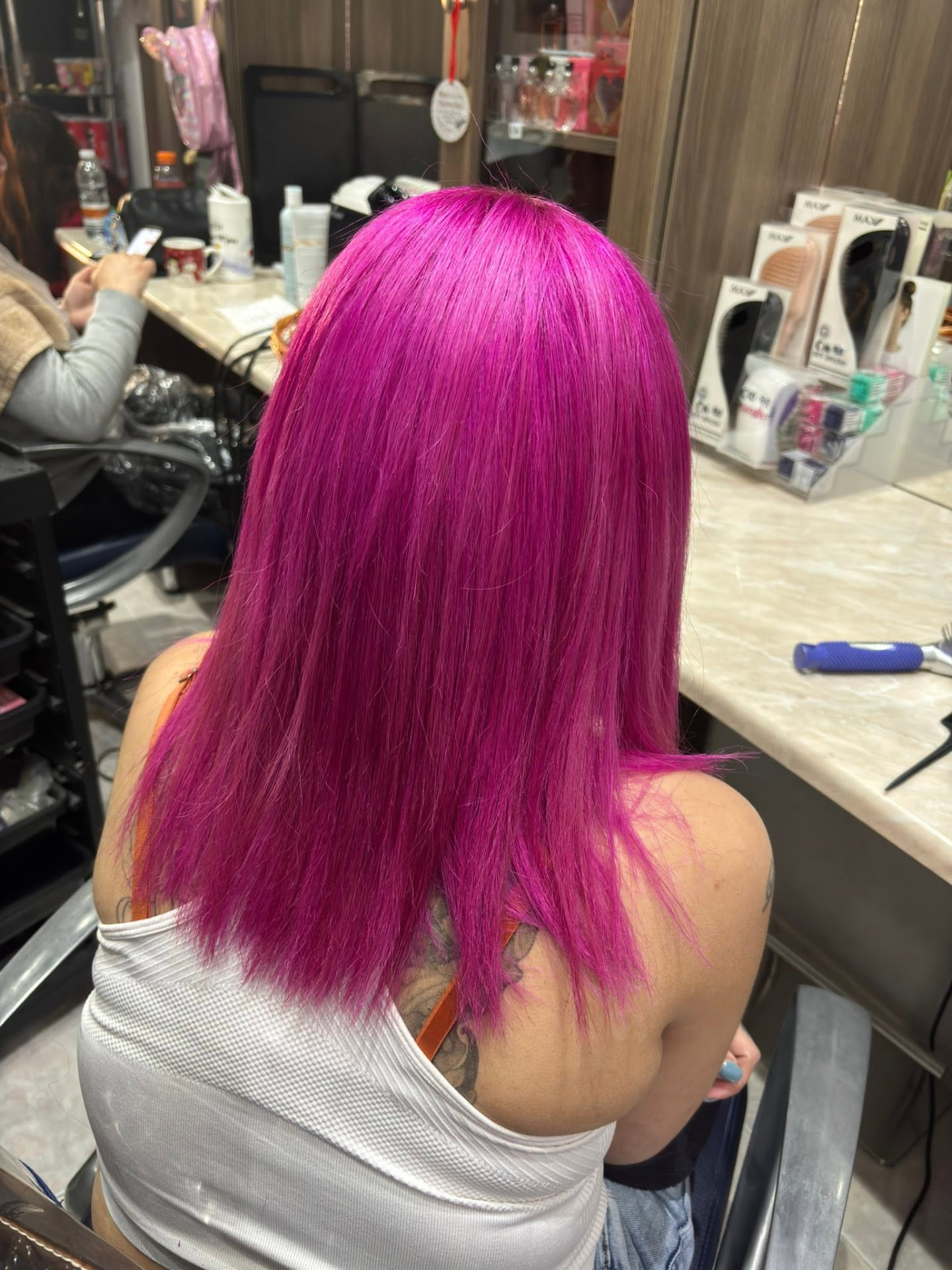 Vibrant magenta neon pink precision hair colour with straight cut